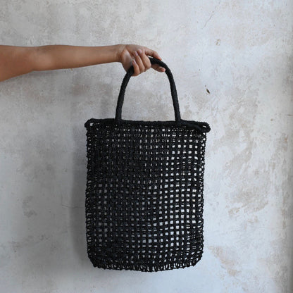 Handwoven by Uri handwoven macrame Toby bag being held by a female model